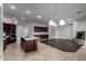 A spacious kitchen features stainless appliances, a stone fireplace, and an island with a sink at 702 E Capricorn Way, Chandler, AZ 85249