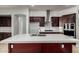 This modern kitchen features stainless appliances, white backsplash and countertops, and an island with a sink at 702 E Capricorn Way, Chandler, AZ 85249