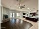 An open-concept living area showcases a stone fireplace, ceiling fan and seamless flow into the well-appointed kitchen at 702 E Capricorn Way, Chandler, AZ 85249
