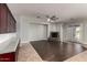 Open concept living room with fireplace, wood flooring, ceiling fan, and lots of natural light at 702 E Capricorn Way, Chandler, AZ 85249
