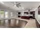 Open concept living area with kitchen, island, stainless steel appliances, and french door access to backyard at 702 E Capricorn Way, Chandler, AZ 85249