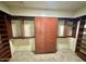 A spacious walk-in closet with built-in shelving and hanging rods that offer optimal storage solutions at 702 E Capricorn Way, Chandler, AZ 85249