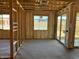 Living room of new construction home with exposed beams and new sliding glass doors and windows at 7700 W Saddlehorn Rd, Peoria, AZ 85383