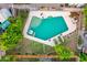 Overhead view of a private swimming pool, surrounded by a patio, lush trees, and a fenced yard at 908 N Creston --, Mesa, AZ 85213