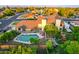 Aerial view of a backyard, showcasing the home, sparkling pool, lush greenery, and outdoor amenities at 908 N Creston --, Mesa, AZ 85213