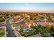 Aerial view showcases a tranquil backyard pool, bordered by greenery, situated in a quiet residential neighborhood at 908 N Creston --, Mesa, AZ 85213