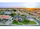 Gorgeous aerial view of a two-story home in a residential neighborhood, featuring manicured lawns at sunset at 908 N Creston --, Mesa, AZ 85213