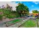 Backyard with raised garden beds, seating area, and mature trees at 908 N Creston --, Mesa, AZ 85213