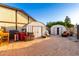 Brick-paved backyard featuring multiple storage sheds and ample storage options at 908 N Creston --, Mesa, AZ 85213