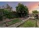 Cozy backyard features mature trees, patio furniture, and garden beds, perfect for relaxing at 908 N Creston --, Mesa, AZ 85213