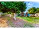 Large grassy backyard with mature fruit trees and playground equipment at 908 N Creston --, Mesa, AZ 85213