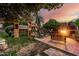 Backyard features mature trees, custom playset, cozy bench and outdoor kitchen at 908 N Creston --, Mesa, AZ 85213
