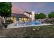 Large in-ground pool with lush backyard landscaping and patio furniture at 908 N Creston --, Mesa, AZ 85213