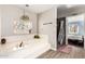 A luxurious bathtub, with an adjacent stone tiled shower and access to the Primary bedroom at 908 N Creston --, Mesa, AZ 85213