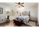 Well-lit bedroom with wood floors, shutters, and a decorative wrought iron headboard at 908 N Creston --, Mesa, AZ 85213