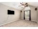 Spacious bedroom with a ceiling fan, peaked ceilings, and a bright window, offering plenty of natural light at 908 N Creston --, Mesa, AZ 85213