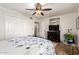 Inviting bedroom with wood flooring, ceiling fan, and a decorative mirror at 908 N Creston --, Mesa, AZ 85213