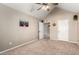 Neutral bedroom with carpet, ceiling fan, closet, and two entry doors and is ready for decor and furnishings at 908 N Creston --, Mesa, AZ 85213