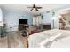 Spacious bedroom with ceiling fan, TV, shelves, and light blue accent wall at 908 N Creston --, Mesa, AZ 85213