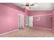 Bedroom featuring pink walls, a zebra art print, a ceiling fan, and a doorway leading to an adjacent room at 908 N Creston --, Mesa, AZ 85213