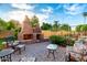 Brick oven and patio area with iron furniture in the backyard at 908 N Creston --, Mesa, AZ 85213