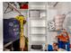 Walk-in closet with open white shelving, clothes hanging on a bar, and toys and belongings at 908 N Creston --, Mesa, AZ 85213