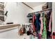 A closet with shelves, hanging rods, and a variety of clothing items and accessories at 908 N Creston --, Mesa, AZ 85213