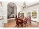 Charming dining room with chandelier, wood table, and view into the living area at 908 N Creston --, Mesa, AZ 85213