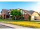 Charming Tudor-style home with brick accents, mature tree, and a green lawn at 908 N Creston --, Mesa, AZ 85213