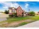 Spacious two-story home featuring a brick facade, arched entryway, and lush landscaping at 908 N Creston --, Mesa, AZ 85213