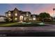 Charming two-story Tudor-style home featuring a brick facade and well-manicured lawn with accent lighting at 908 N Creston --, Mesa, AZ 85213