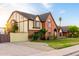 Two-story Tudor-style home with brick and stucco exterior, gated RV parking, and lush landscaping at 908 N Creston --, Mesa, AZ 85213