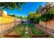 Backyard with raised garden beds, seating area, and privacy fence at 908 N Creston --, Mesa, AZ 85213