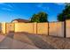 View of a wooden gate and beige stucco wall offering privacy to the yard in the suburban home at 908 N Creston --, Mesa, AZ 85213