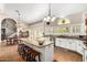 Bright kitchen with granite counters, large island with seating, stainless appliances, and lots of windows at 908 N Creston --, Mesa, AZ 85213