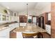 Large kitchen with an oversized island, granite counters, brick oven, stainless steel appliances, and a vaulted ceiling at 908 N Creston --, Mesa, AZ 85213