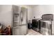 Laundry area featuring a modern washer/dryer and stainless-steel refrigerator at 908 N Creston --, Mesa, AZ 85213