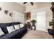 Comfortable carpeted living room features a couch, desk and bright lighting at 908 N Creston --, Mesa, AZ 85213