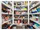 Walk-in pantry with shelving full of food and supplies providing ample storage at 908 N Creston --, Mesa, AZ 85213