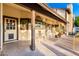 Charming covered patio with rocking chairs, plants, and ample space for relaxation and enjoying the outdoors at 908 N Creston --, Mesa, AZ 85213