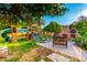 Spacious backyard with play structure, pizza oven, brick patio, and mature shade trees at 908 N Creston --, Mesa, AZ 85213
