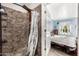 A unique walk-in shower featuring stone tile, a rainfall shower head and pebble flooring at 908 N Creston --, Mesa, AZ 85213