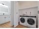 Convenient laundry area next to bathroom with washer, dryer, and shelving at 9600 N 96Th St # 216, Scottsdale, AZ 85258