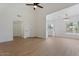 Bright living room with high ceiling, ceiling fan, modern light fixture, and wood-look flooring at 9600 N 96Th St # 216, Scottsdale, AZ 85258