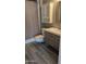 Updated bathroom features modern vanity, cabinet, and plank flooring at 10039 W Lancaster Dr, Sun City, AZ 85351