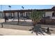 Exterior view of the home with a pergola and desert landscaping at 10039 W Lancaster Dr, Sun City, AZ 85351