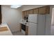 Efficient kitchen with white appliances, ample cabinets, and laminate counters at 10039 W Lancaster Dr, Sun City, AZ 85351