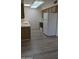 Kitchen showcases wood-look floors, laminate counters, and white appliances at 10039 W Lancaster Dr, Sun City, AZ 85351