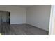 Living room features wood-look floors, neutral walls, and ample natural light at 10039 W Lancaster Dr, Sun City, AZ 85351