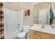Clean bathroom with single sink vanity, tub with shower, and framed mirror at 10583 S 175Th Ave, Goodyear, AZ 85338